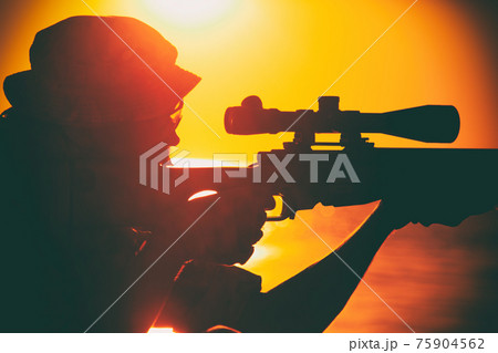 Commando sniper aiming, shooting rifle on seacoast 75904562