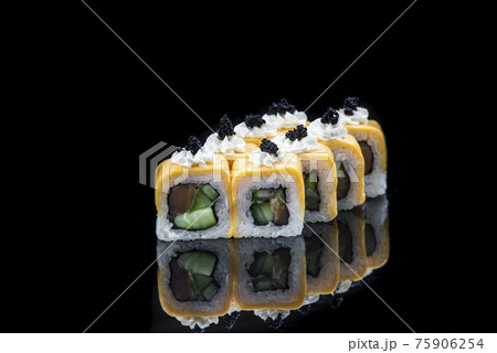 Sushi rolls with salmon, tuna, cucumber and green onions on black background Sushi rolls with salmon, tuna, cucumber and green onions on black background 75906254