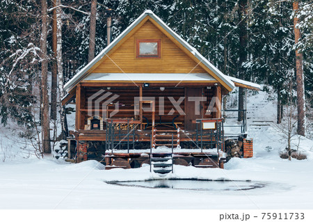 russian sauna banya house in winter forest nearby the lake with ice-hole 75911733
