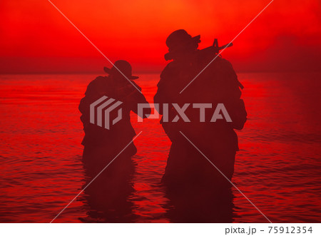 Commando soldiers walking in water and aiming gun Commando soldiers walking in water and aiming gun 75912354