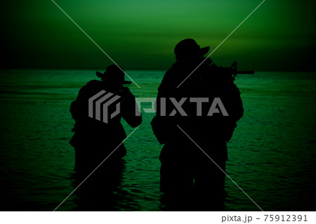 Coast guard soldiers landing on shore at sunset Coast guard soldiers landing on shore at sunset 75912391