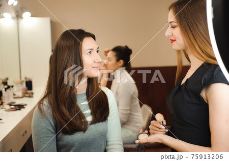 Make up artist doing professional make up of young woman. Beauty shcool. Make up artist doing professional make up of young woman. Beauty shcool. 75913206