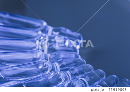 Glass medical ampoule vial for injection. Medicine is liquid sodium chloride with of aqueous solution in ampulla. Close up. Bottles ampule multicolor. Glass medical ampoule vial for injection. Medicine is liquid sodium chloride with of aqueous solution in ampulla. Close up. Bottles ampule multicolor. 75919093