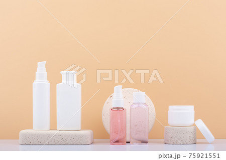 Set of skin care products on neutral stone podiums against beige background with copy space. Concept of daily skin care  75921551