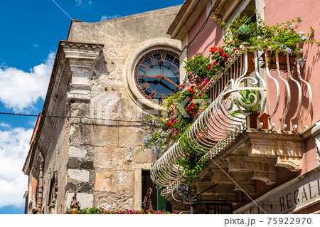 Typical Sicilian balcony in Taormina full of flowers and decorations 75922970