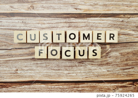 Customer Focus alphabet letter on wooden background 75924265