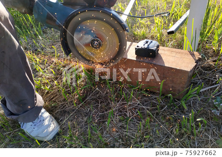Cutting bricks with an angle grinder, construction work, the process of execution close-up. 75927662