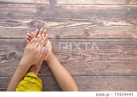 close up of child hand holding senior women's hand close up of child hand holding senior women's hand 75929445
