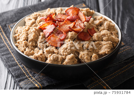 Rustic style Ajdovi zganci Slovenian buckwheat porridge served with cracklings close-up in a bowl. horizontal 75931784