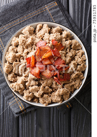 Ajdovi zganci Slovenian national dish of buckwheat flour and fried bacon close-up in a bowl. vertical top view 75931785