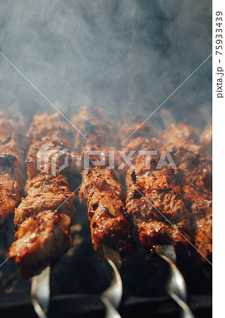 grilled barbecue meat on skewers with smoke grilled barbecue meat on skewers with smoke 75933439