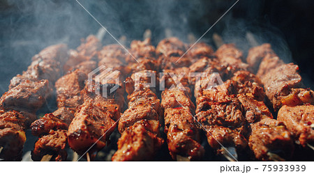 grilled barbecue meat on skewers with smoke grilled barbecue meat on skewers with smoke 75933939