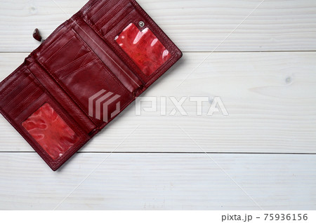 Leather purse on a white wooden background Leather purse on a white wooden background 75936156