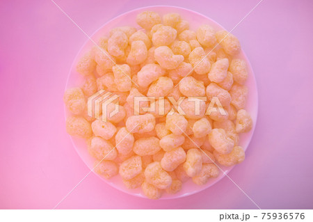 Corn sticks in sugar powder on a plate. Sweet food background 75936576