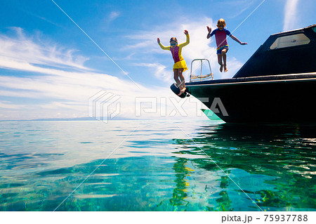 Child jumping into sea water. Yacht vacation. Child jumping into sea water. Yacht vacation. 75937788