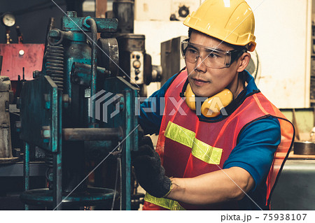 Skillful factory worker or engineer do machine job in manufacturing workshop 75938107