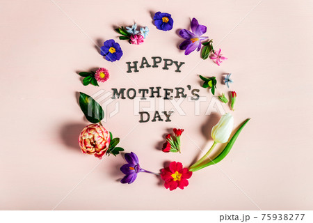 Happy Mothers Day letters with different spring flowers around them 75938277