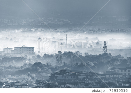 Fog and smoke above city district at sunrise. Lijiang. 75939556