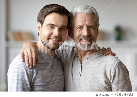 Portrait of happy old father and adult son hugging Portrait of happy old father and adult son hugging 75954732