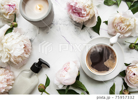 Pink peony flowers and cup of coffee 75957332