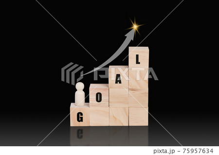 Wooden block stacking as a growth on top with word GOAL and arrow up. 75957634