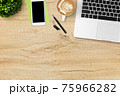 Wood office desk table with laptop computer, latte coffee, smartphone and supplies. Top view with copy space, flat lay. 75966282