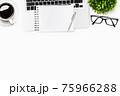 Modern white office desk table with laptop, blank notebook, and supplies. Top view with copy space, flat lay. 75966288