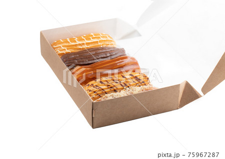 Set of five eclairs with various fillings in box isolate on white Set of five eclairs with various fillings in box isolate on white 75967287