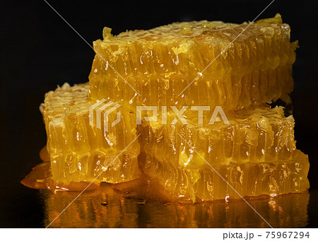 Yellow honey comb slice on black background 75967294