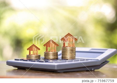 Wooden house designs on coins, including real estate investment ideas calculator. 75967759