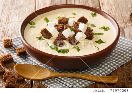 Homemade Bryndza soup with vegetables served with croutons close-up in a plate. horizontal 75970063