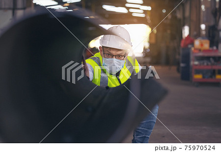 Engineers examine new coated pipe in factory, Ventory Check Engineers examine new coated pipe in factory, Ventory Check 75970524