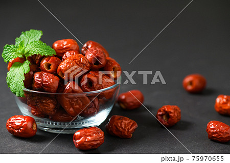 Dried Jujube, Chinese dried red date fruit with Mint leaves in glass cup 75970655