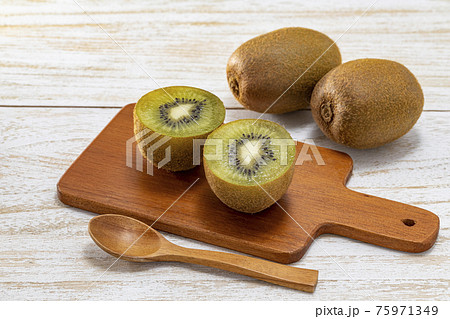 白い木目テーブルに置いた完熟のグリーンキウイ 白い木目テーブルに置いた完熟のグリーンキウイ 75971349