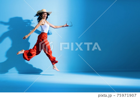 Portrait of a cheerful lady enjoying a summer weather Portrait of a cheerful lady enjoying a summer weather 75971907