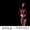 Portrait of a young, brunette, classy woman posing in shade 75971917