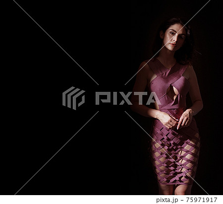 Portrait of a young, brunette, classy woman posing in shade 75971917
