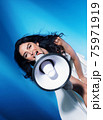 Elegant woman yelling with a bullhorn - communication concept 75971919