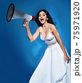 Elegant woman yelling with a bullhorn - communication concept 75971920