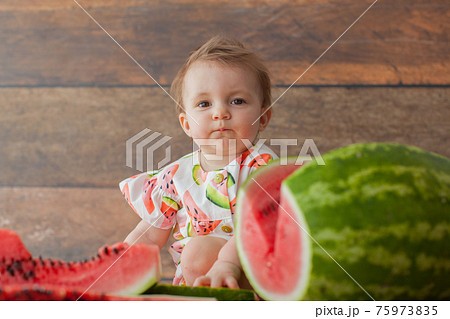 One year old baby girl eats watermelon. One year old baby girl eats watermelon. 75973835