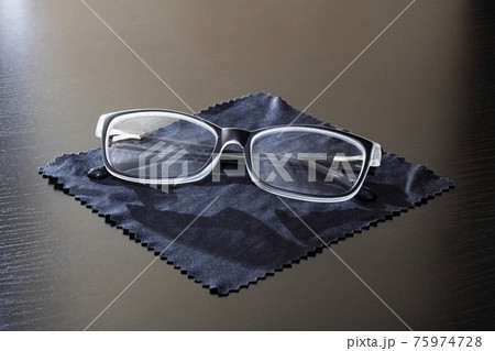 Glasses on a black napkin on a wooden table 75974728