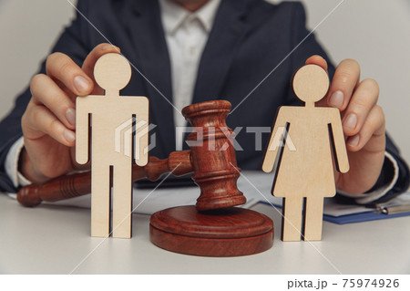 Lawyer or counselor holds figures of family, divorce or separation concept. Close-up 75974926