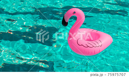 Flamingo print. Pink inflatable flamingo in pool water for summer beach background. Minimal summer concept. 75975707