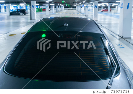 Parking space. Empty road asphalt background. Car lot parking space in underground city garage. Hidden underground carpark. Parking space. Empty road asphalt background. Car lot parking space in underground city garage. Hidden underground carpark. 75975713