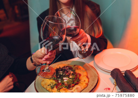 Clinking glasses with alcohol and toasting, party. Clinking glasses with alcohol and toasting, party. 75975880