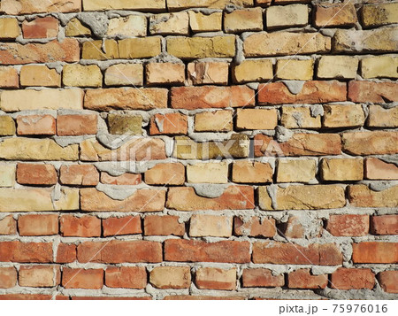 Brick wall of an old building. Cement between rows of bricks Brick wall of an old building. Cement between rows of bricks 75976016