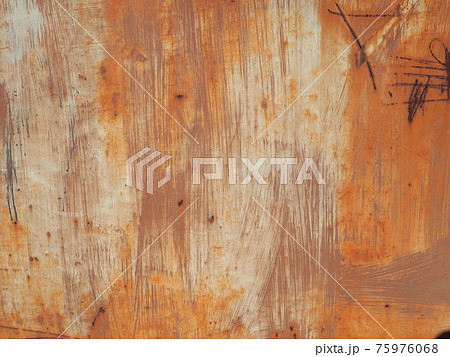 rusty scratched metal. The metal surface has long been painted yellow-orange. Rust and damage. Wear over time and use rusty scratched metal. The metal surface has long been painted yellow-orange. Rust and damage. Wear over time and use 75976068