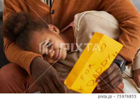 Loving African-American Girl Cuddling with Father 75976855