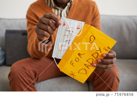 Man Opening Handmade Gift on Fathers Day 75976856