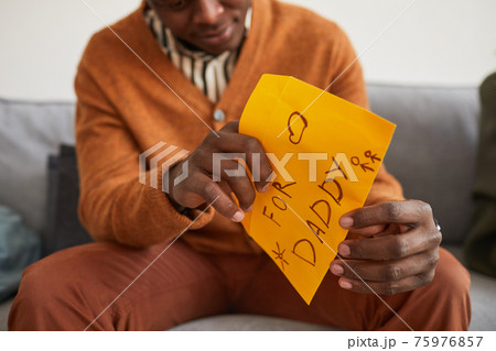 Man Opening Letter from Son 75976857